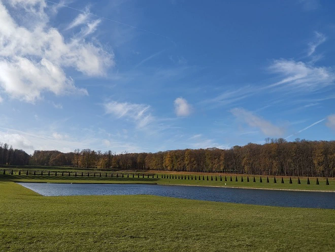 Photographie présentant le Parc et son plan d'eau, un jour d'automne